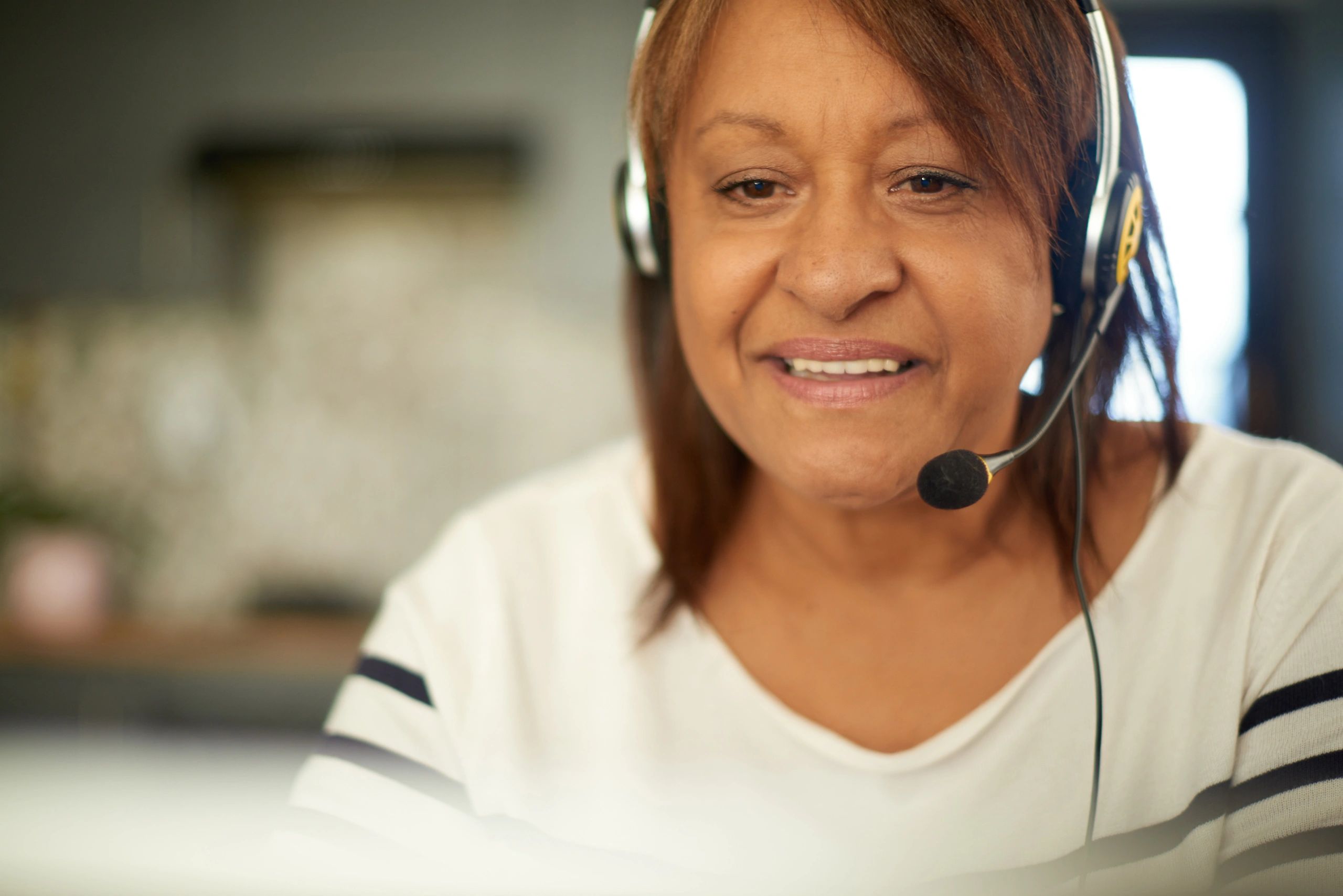 Support specialist wearing a headset, ready to take a call